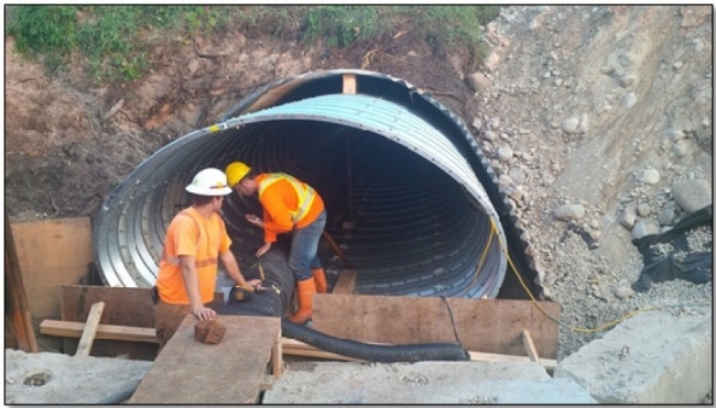 Workers installing a culvert