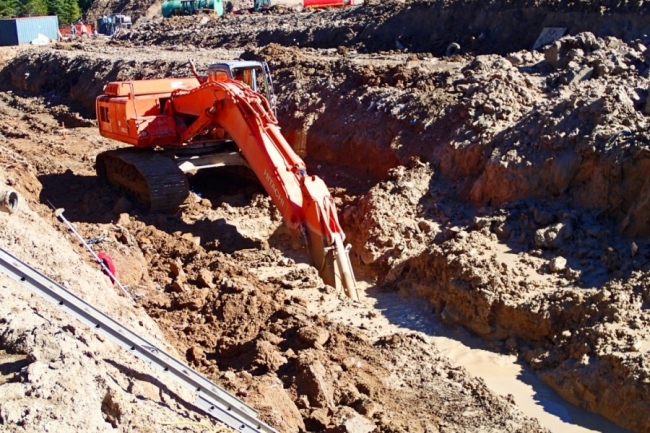 An excavator digging a trench