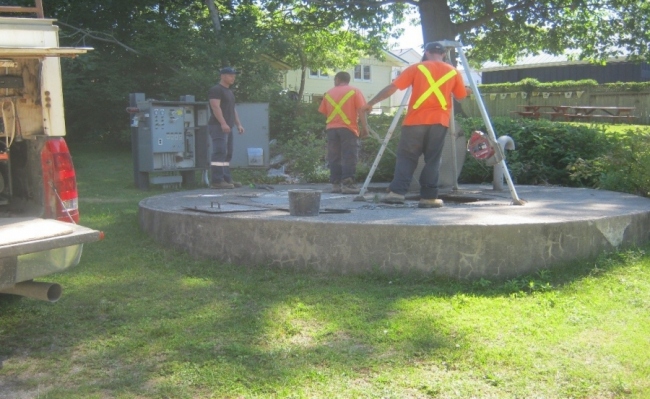 Workers maintaining a sewage pumping station
